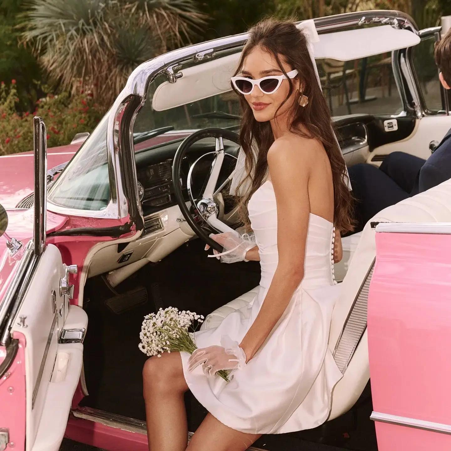 Model wearing a white gown by Rebecca Ingram