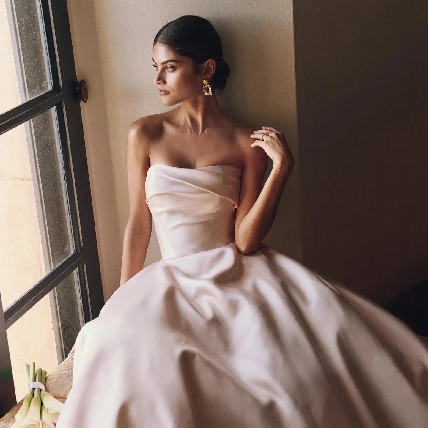 Model wearing a white gown by Sottero And Midgley